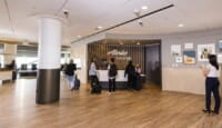 a group of people standing at a reception desk