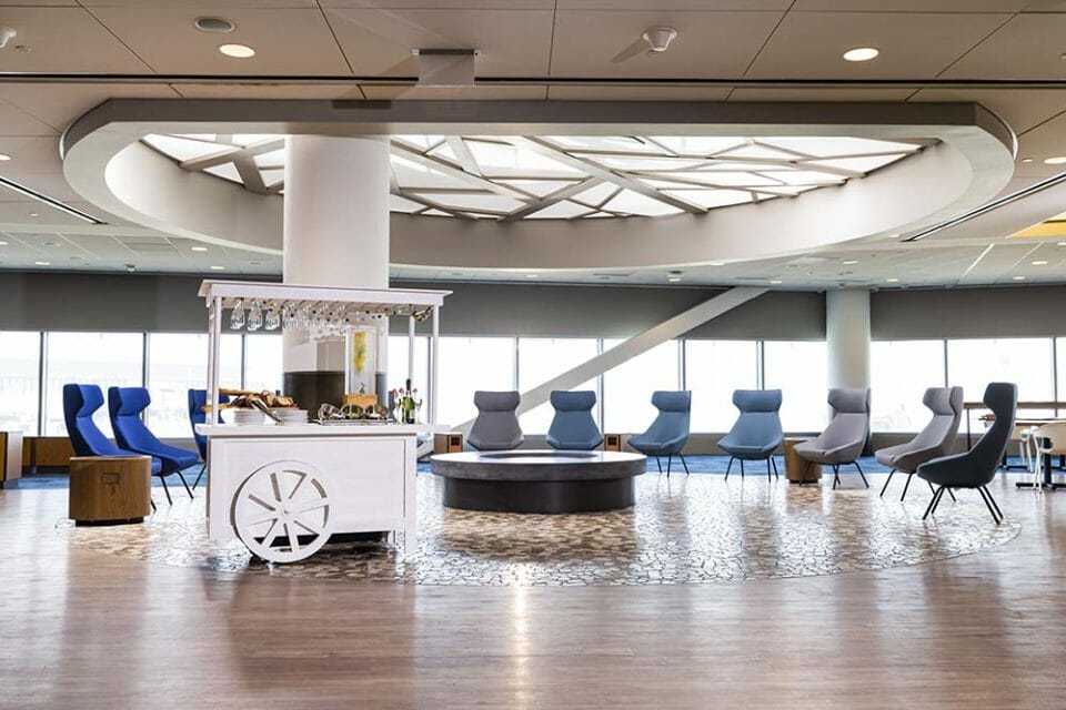 a room with a cart and chairs