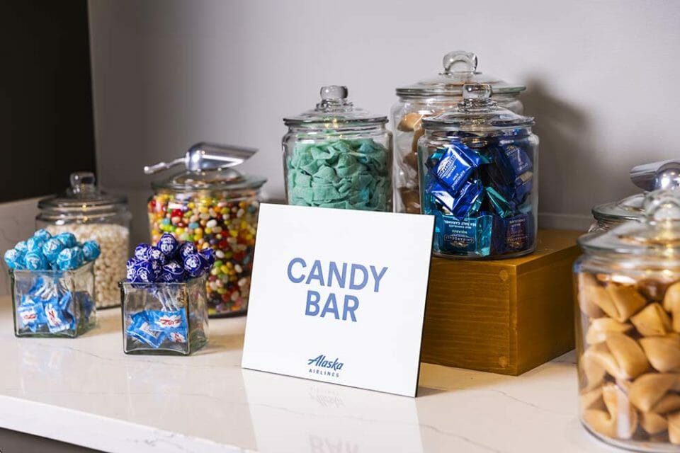 a group of glass jars with different colored candies
