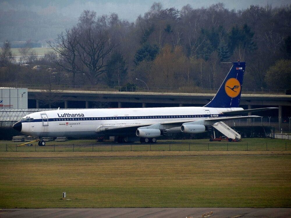 a large white airplane on a runway