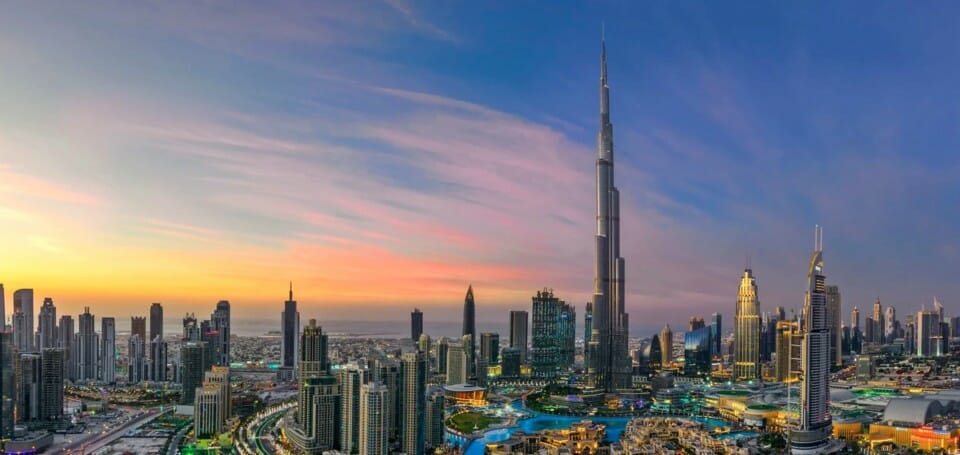 a city skyline with a tall tower