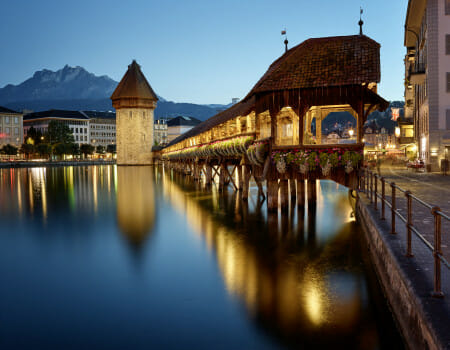 Kapellbrücke over water with a tower and buildings in the background