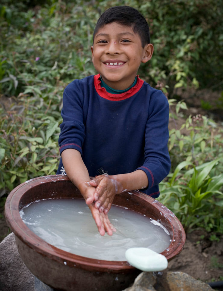 a boy washing his hands