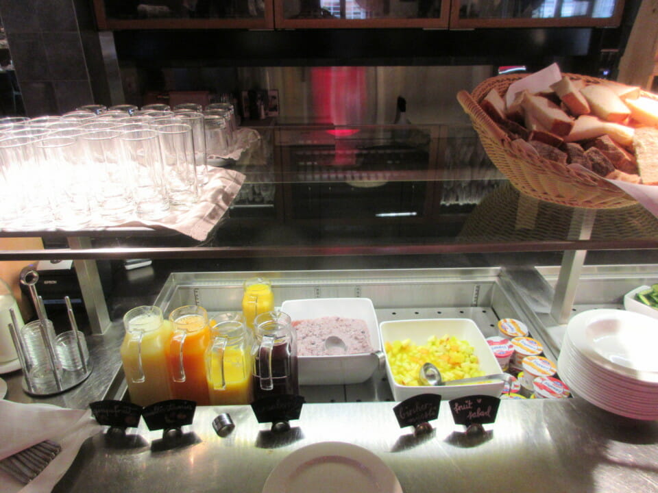 a buffet with a variety of drinks and bread