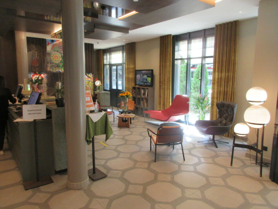 a room with a reception desk and chairs