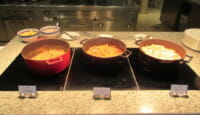 a group of pots of food on a counter