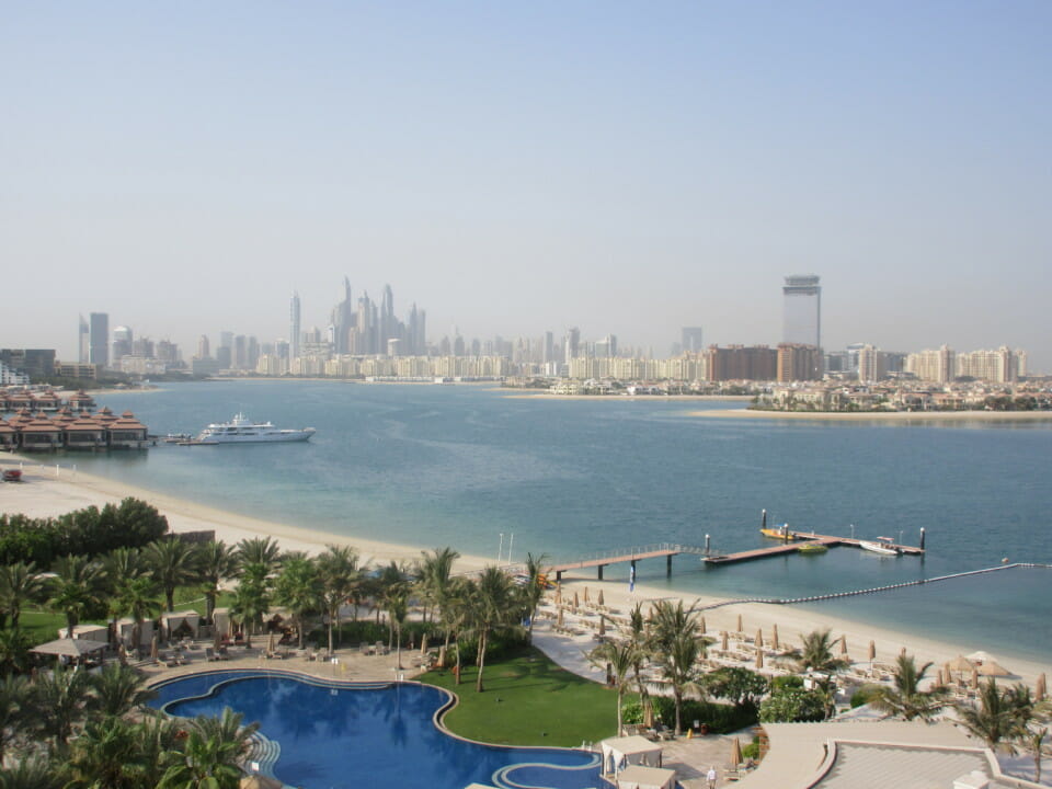 a body of water with a city in the background