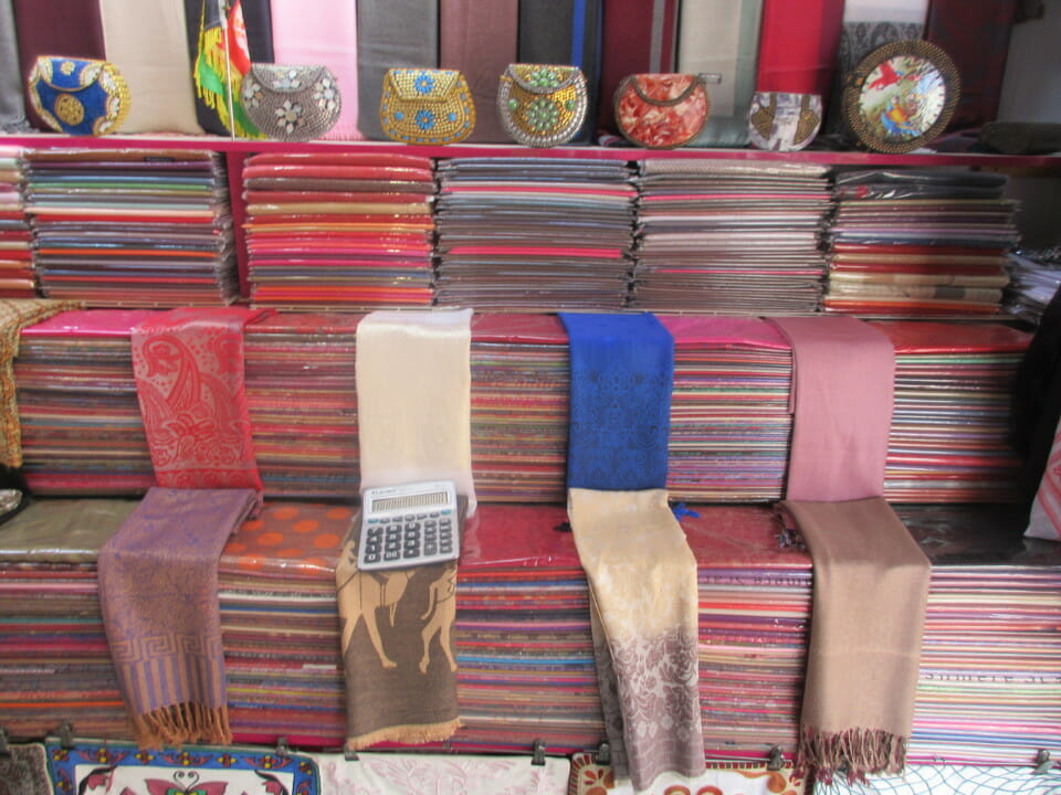 a stack of colorful scarves