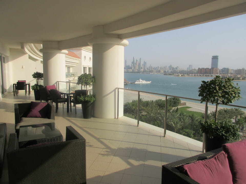 a balcony with a view of a city and water