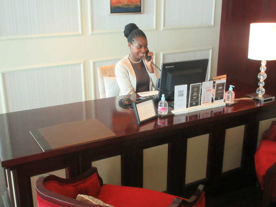 a woman sitting at a desk talking on the phone