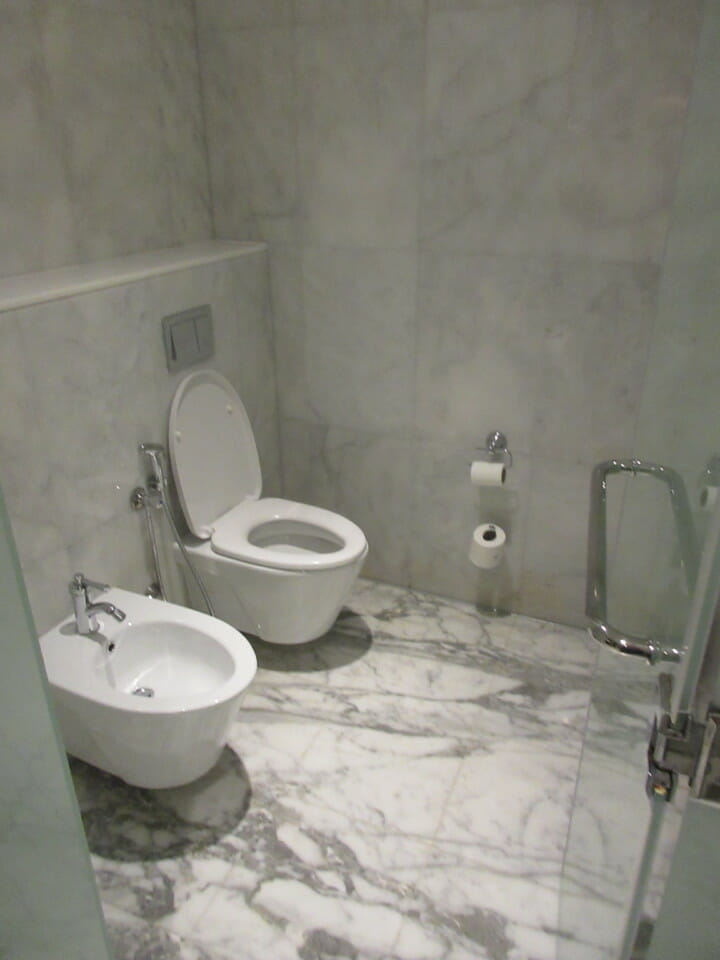 a bathroom with a toilet and bidet