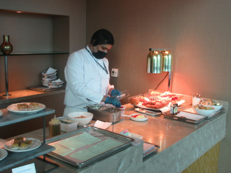 a man wearing a mask and gloves preparing food