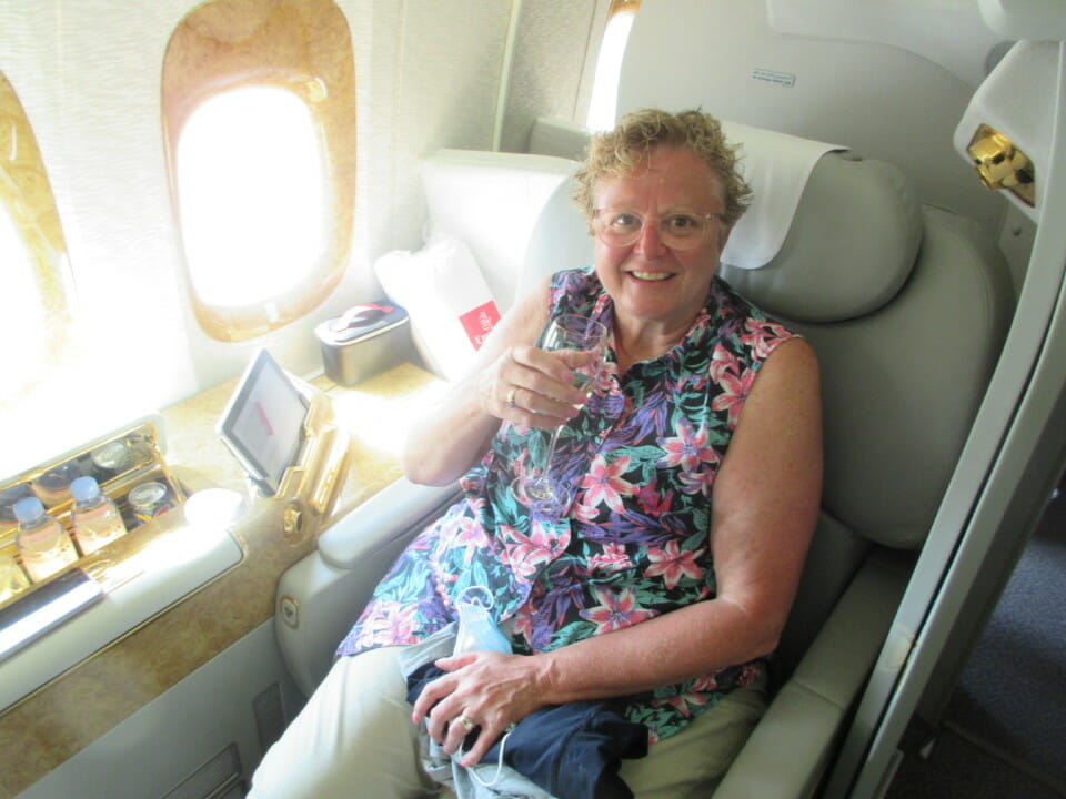 a woman sitting in a chair holding a glass of wine