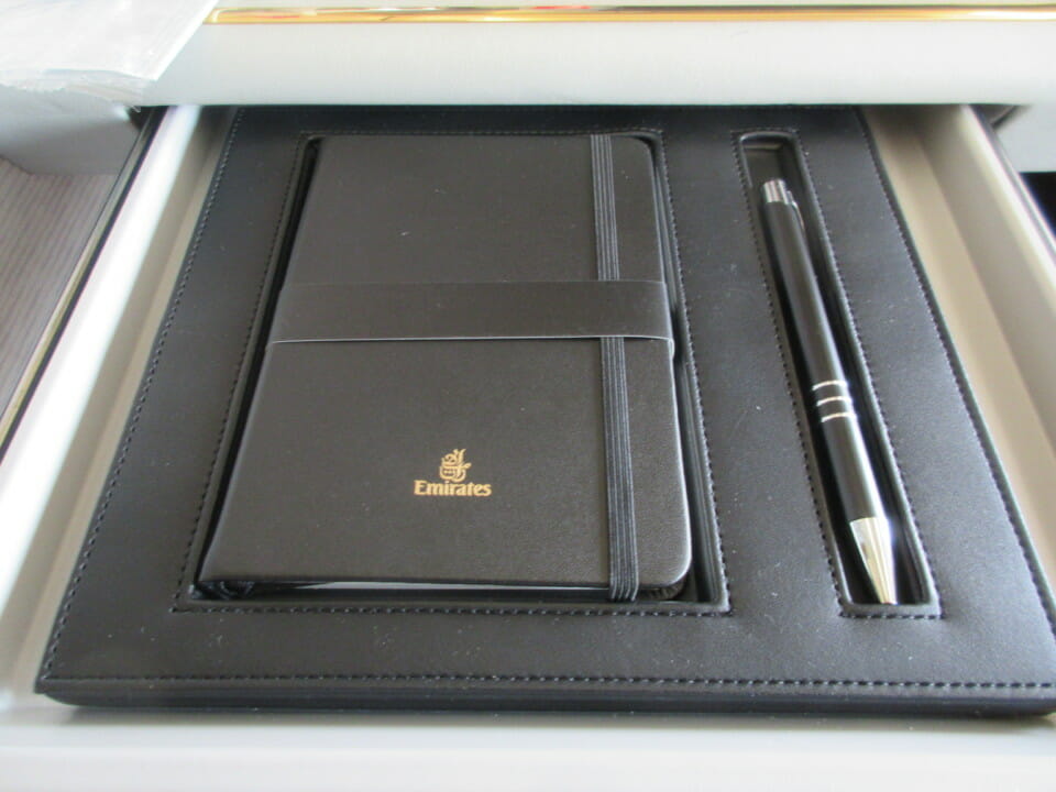 a black notebook and pen in a tray