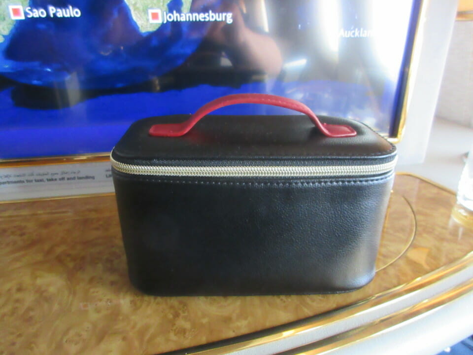a black bag with a red handle