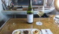 a wine bottle and a plate of food on a table