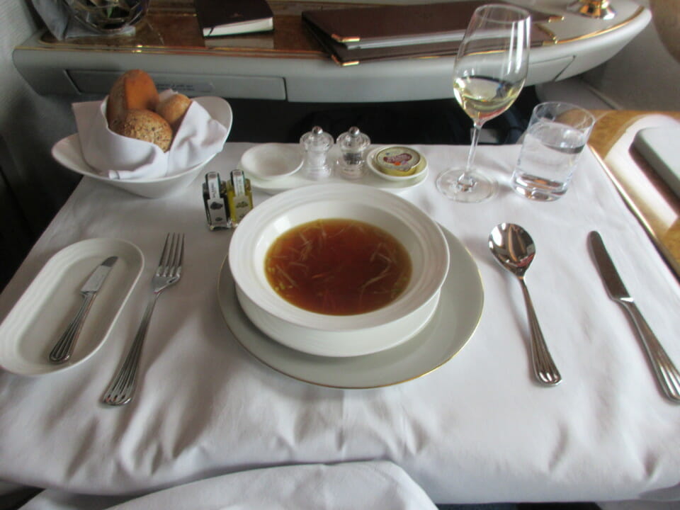 a table with a bowl of soup and silverware