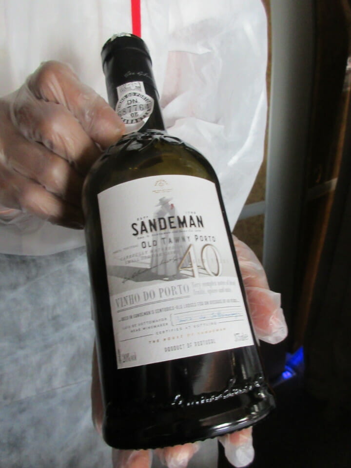 a person holding a bottle of wine