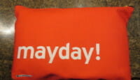 a red pillow with white text on it