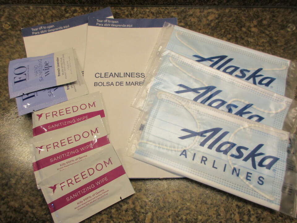 a group of face masks and packets of sanitizer