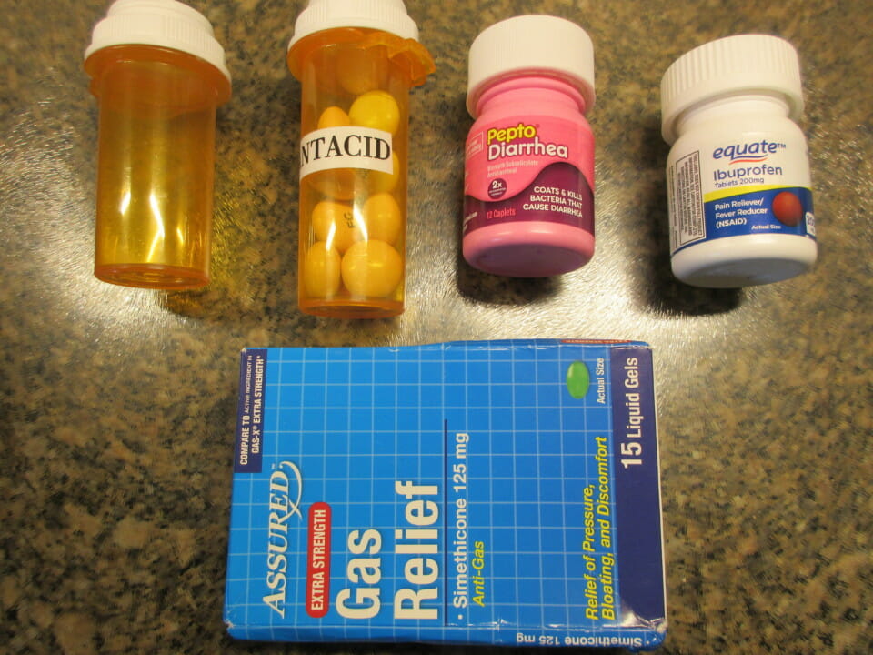 a group of pills and a blue box