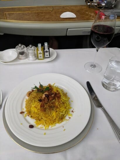 a plate of rice and a glass of wine