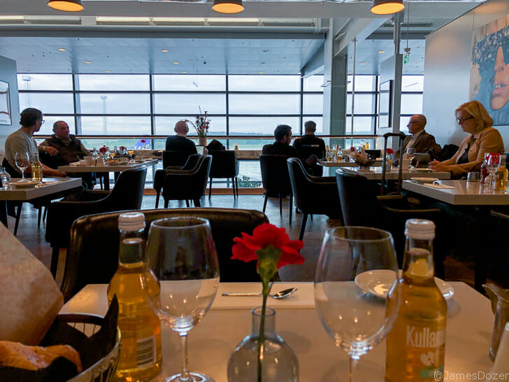 a group of people sitting at tables in a restaurant