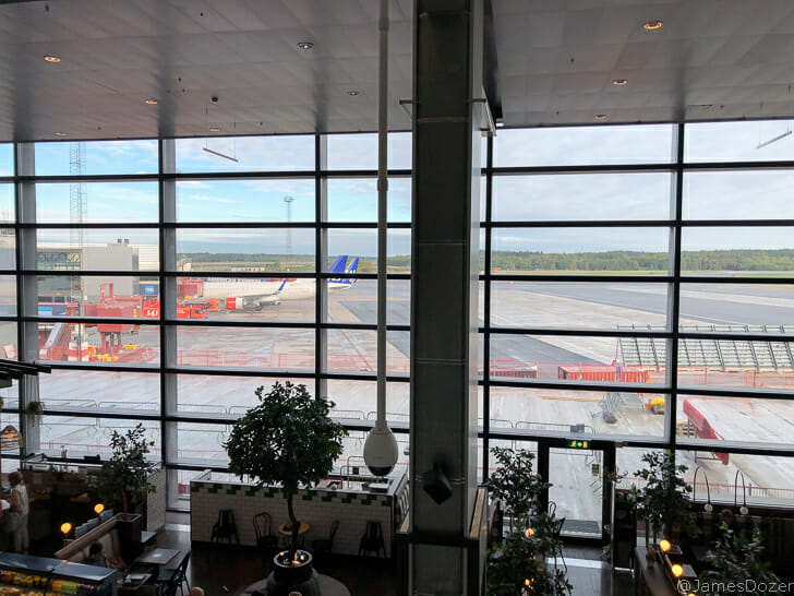 a large glass window with a plane in the background