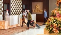 a group of people walking in a hotel