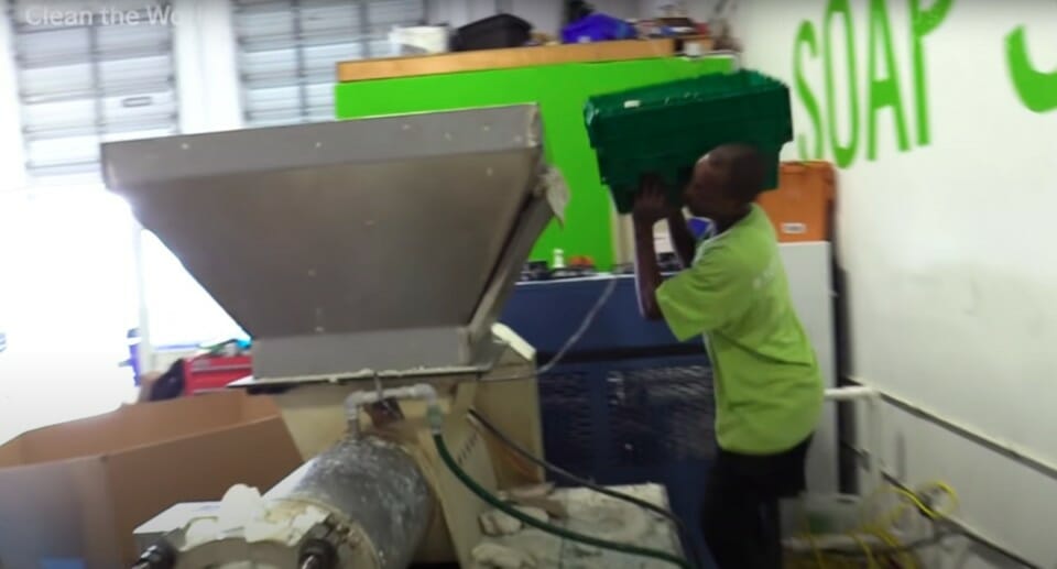 a man holding a green container