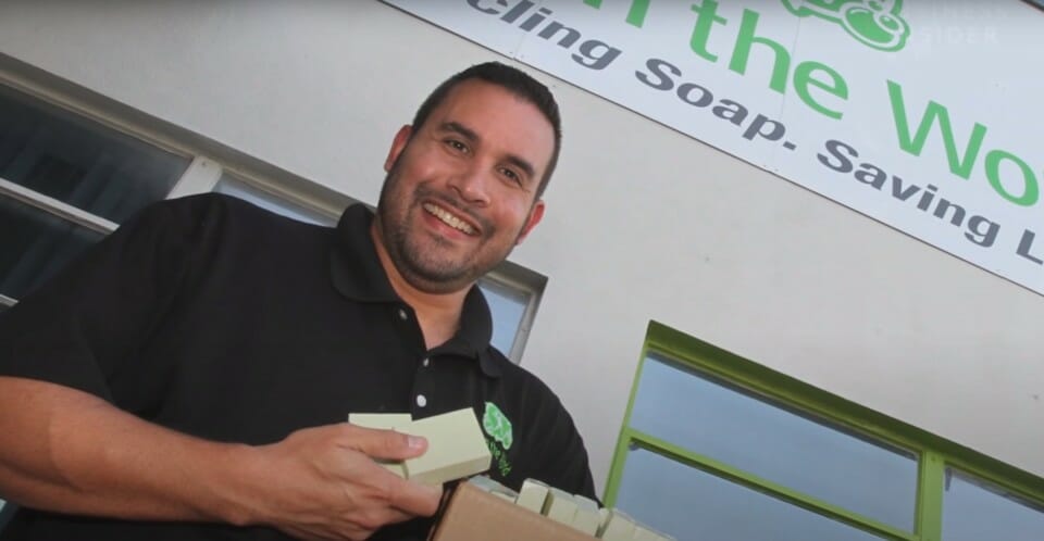 a man holding boxes of soap