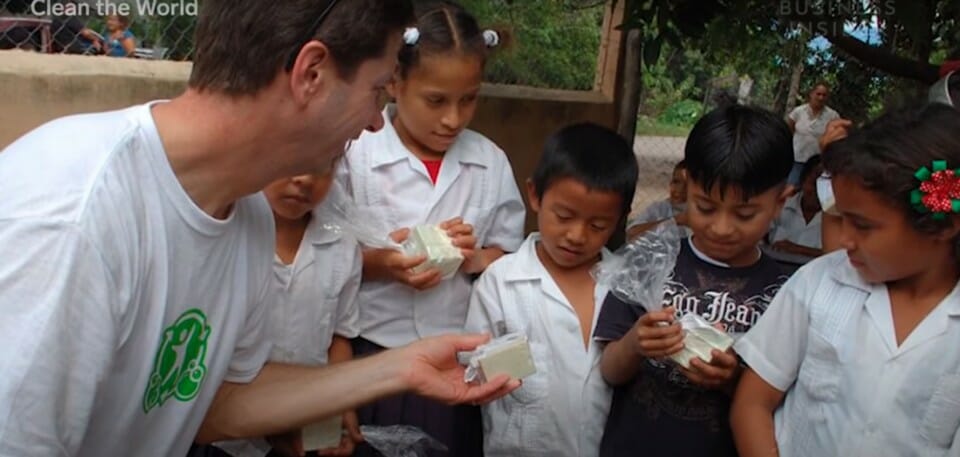 a man giving a package to children