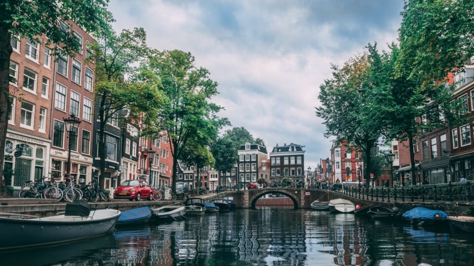 a canal with boats and buildings in the background