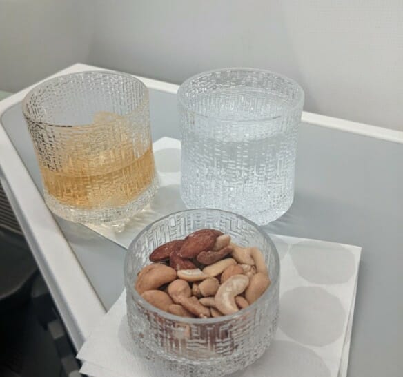 a bowl of nuts and a glass of water