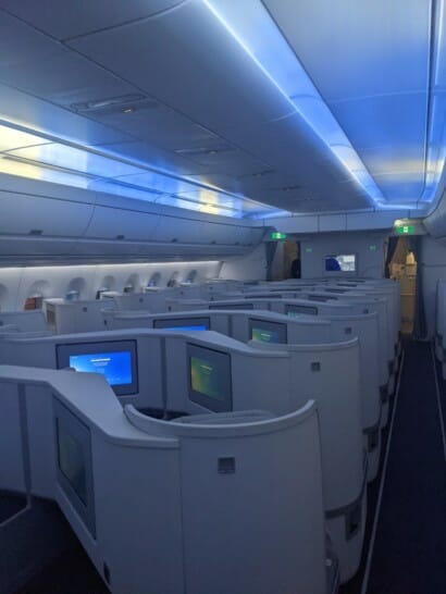 an airplane with rows of seats and monitors