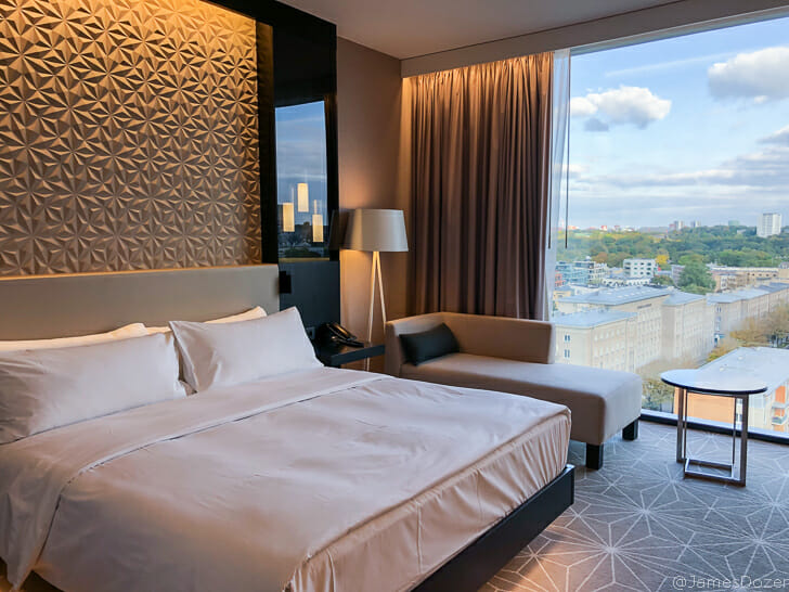 a room with a bed and a table and chairs