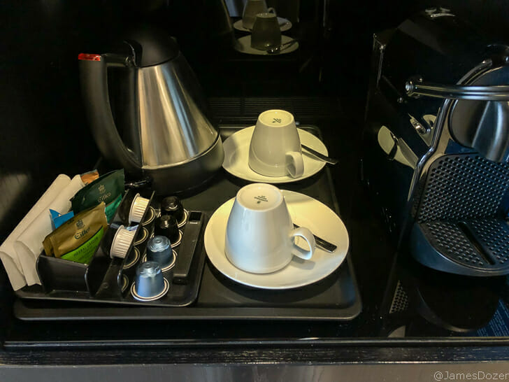 a coffee machine and cups on a tray