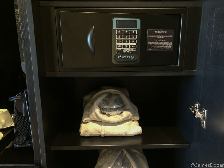 a black safe with a combination lock and a white towel on it