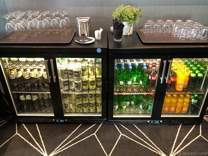 a refrigerator with drinks and glasses on top