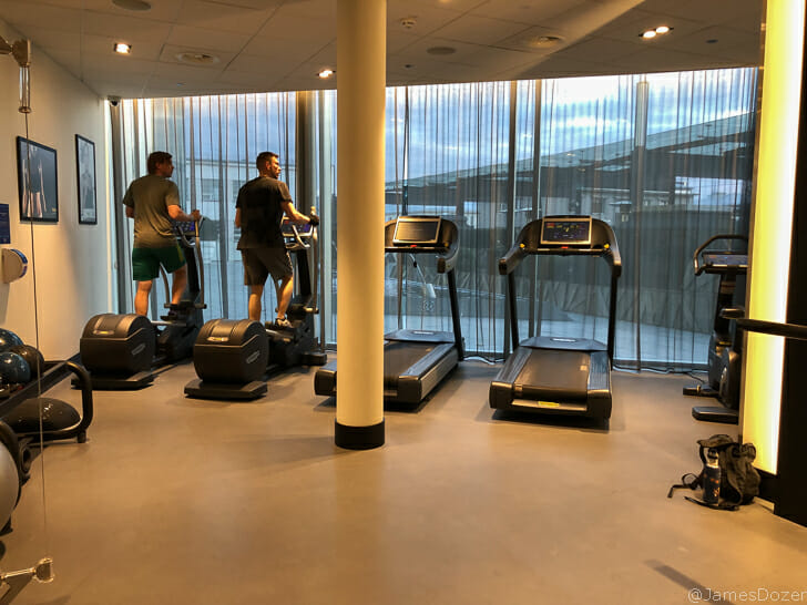 a group of people on treadmills in a gym