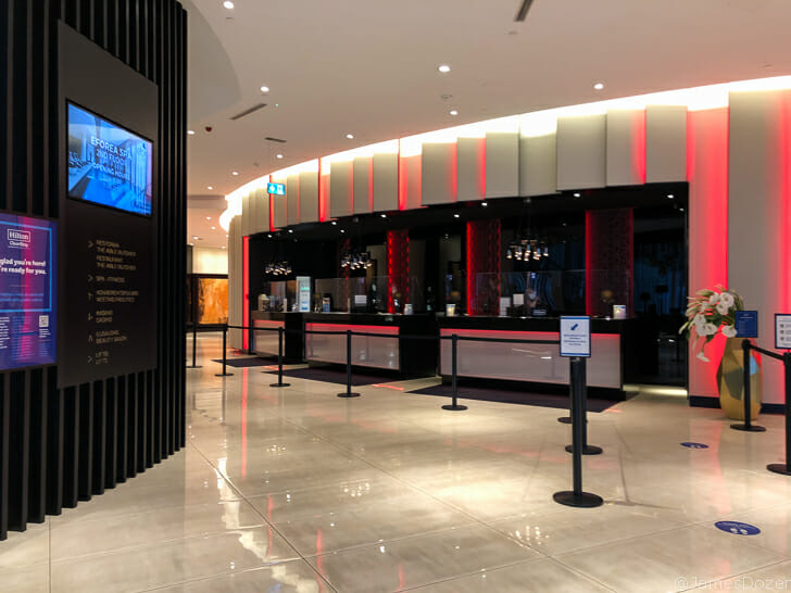 a lobby with a sign and a bar