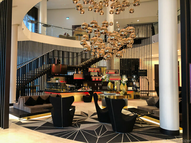 a room with a staircase and a chandelier