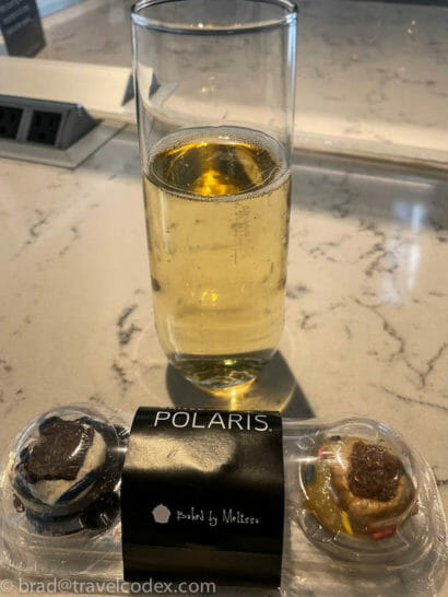 a glass of wine next to a glass of liquid
