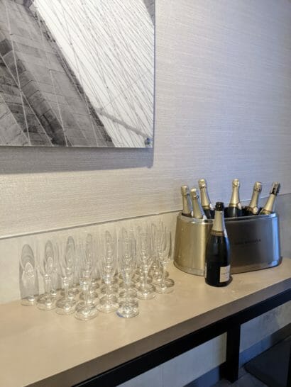 a group of champagne glasses and a bucket of champagne