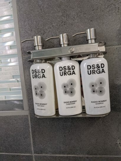 a group of white bottles on a metal shelf