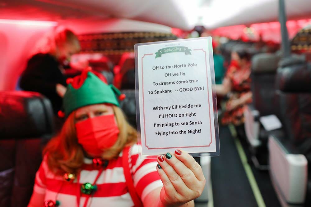 a woman holding a sign in a plane