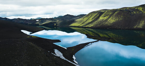 a body of water with mountains in the background
