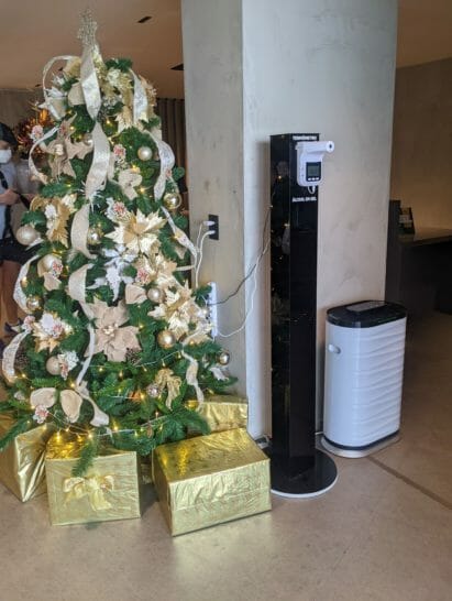 a christmas tree with presents next to a machine