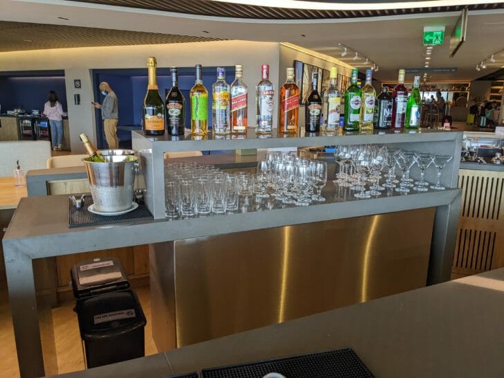 a shelf with bottles and glasses on it