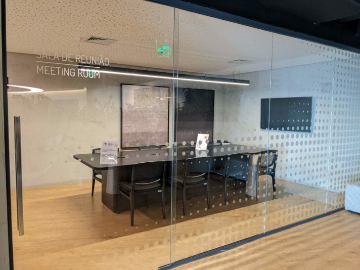 a glass wall with a table and chairs
